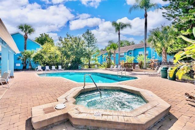 view of pool featuring a hot tub and a patio