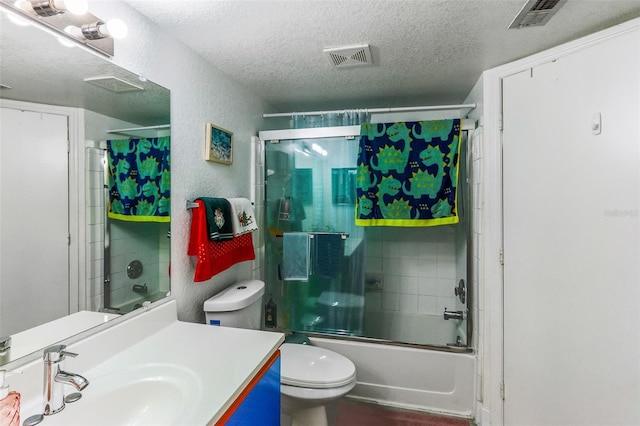 full bathroom with vanity, toilet, shower / bath combination with glass door, and a textured ceiling