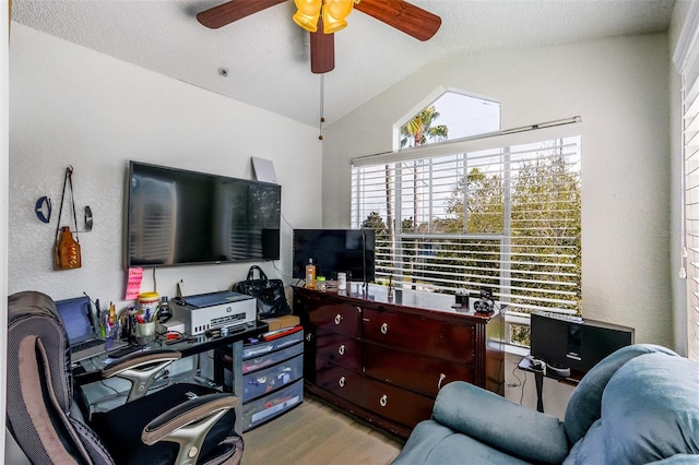 office area with lofted ceiling, a textured ceiling, ceiling fan, and light hardwood / wood-style flooring