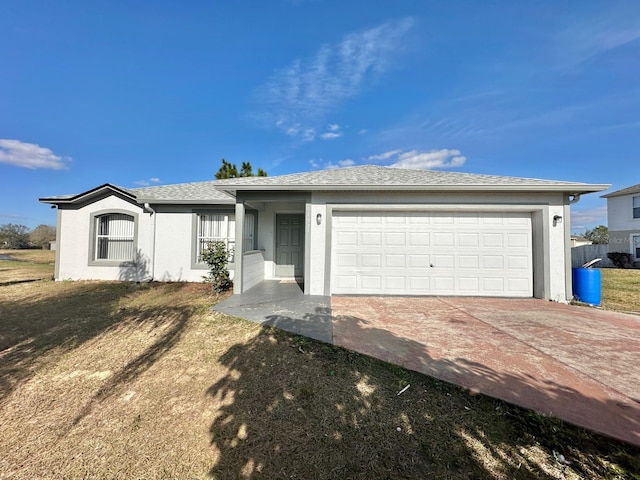 ranch-style home with a garage and a front lawn