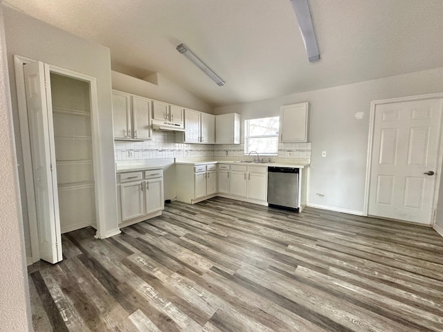 kitchen with white cabinetry, dark wood-type flooring, dishwasher, and vaulted ceiling