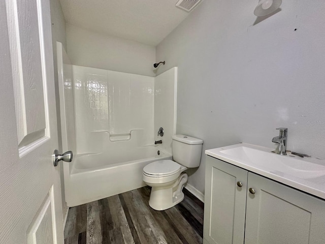 full bathroom with vanity, hardwood / wood-style flooring,  shower combination, and toilet