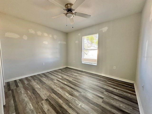 empty room with dark wood-type flooring and ceiling fan