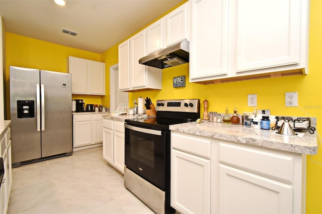 kitchen featuring white cabinetry, stainless steel appliances, and light tile patterned floors