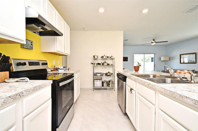 kitchen featuring light tile patterned flooring, sink, appliances with stainless steel finishes, ceiling fan, and white cabinets