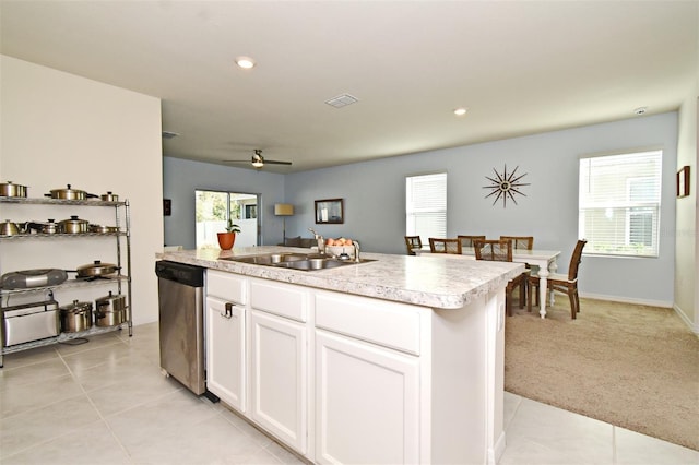 kitchen featuring white cabinetry, dishwasher, sink, a center island with sink, and light carpet