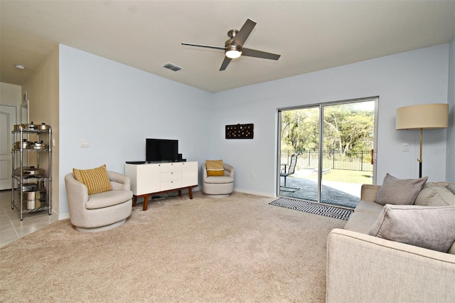 carpeted living room with ceiling fan