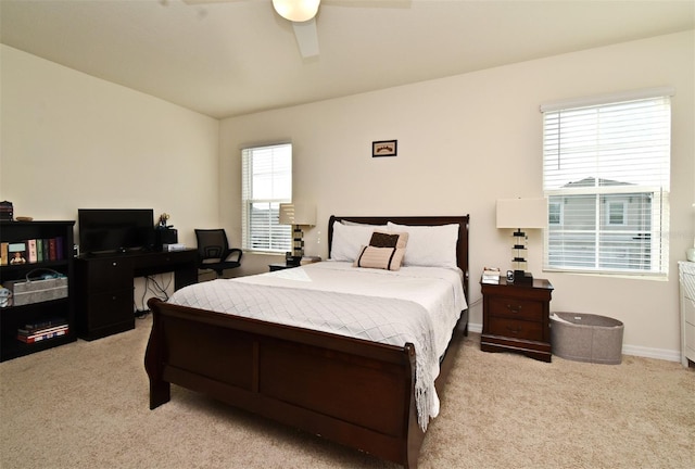 bedroom featuring light carpet and ceiling fan