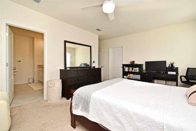 carpeted bedroom with ceiling fan and ensuite bathroom