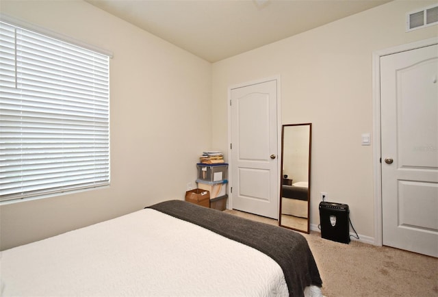 bedroom featuring light carpet