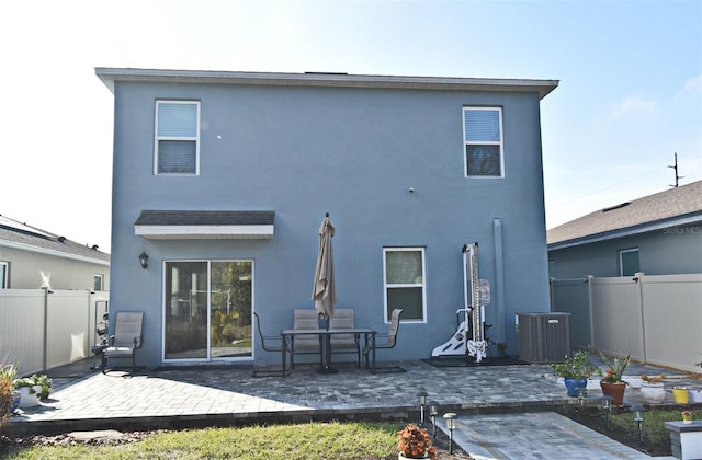 back of house with cooling unit and a patio area