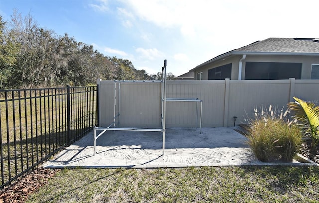 view of gate with a yard