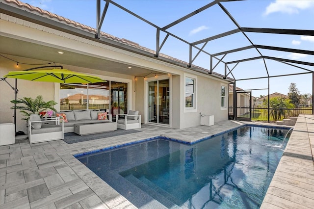 view of pool with pool water feature, outdoor lounge area, glass enclosure, and a patio