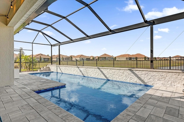 view of swimming pool with a lanai and a patio