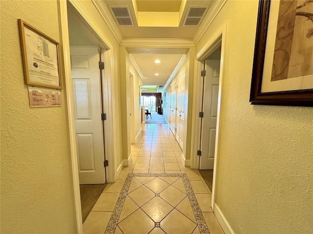 hallway featuring crown molding and light tile patterned floors