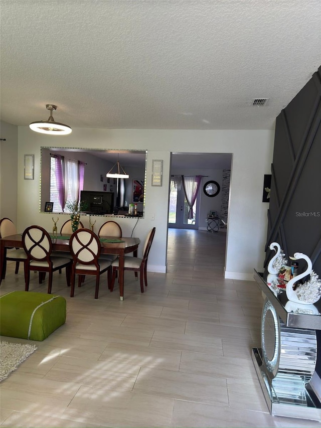 dining space with a textured ceiling