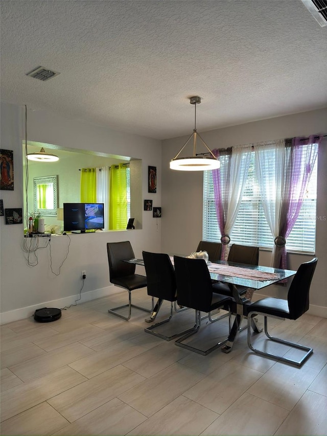 dining space with a textured ceiling