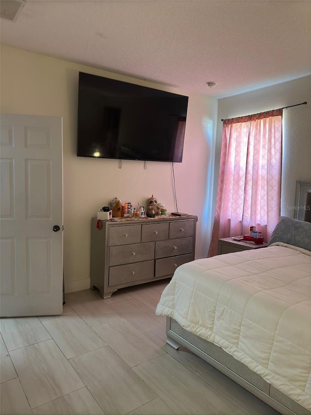 bedroom featuring a textured ceiling