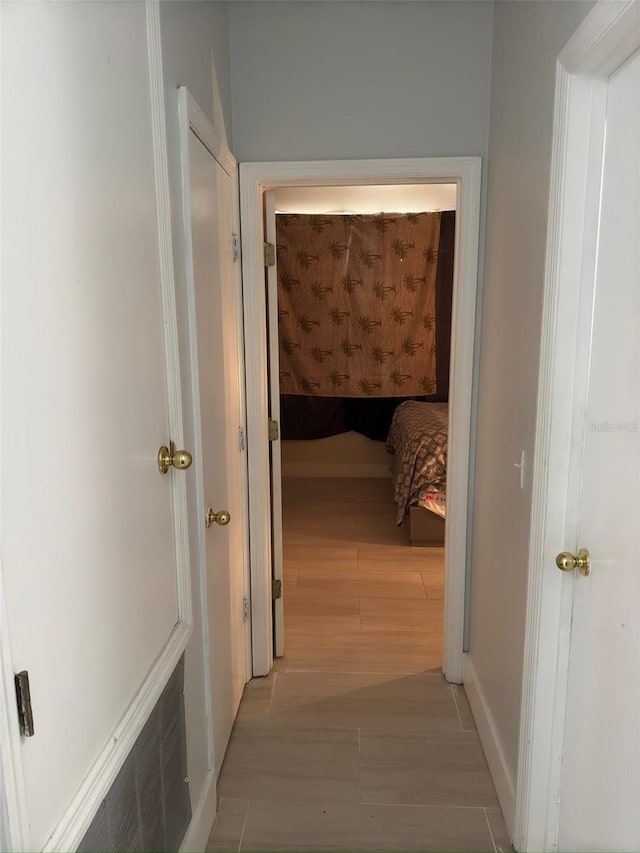 corridor with light hardwood / wood-style floors