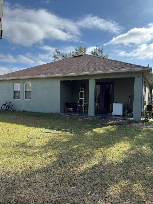 rear view of property with a lawn