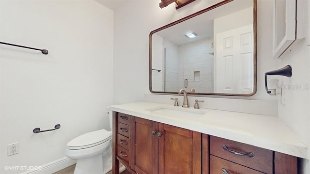 bathroom with vanity, an enclosed shower, and toilet