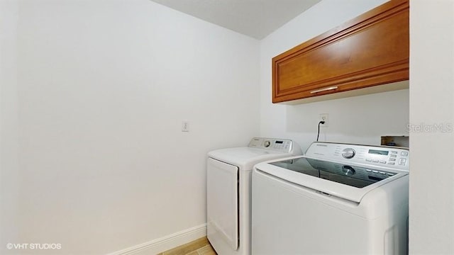 laundry room with cabinets and separate washer and dryer