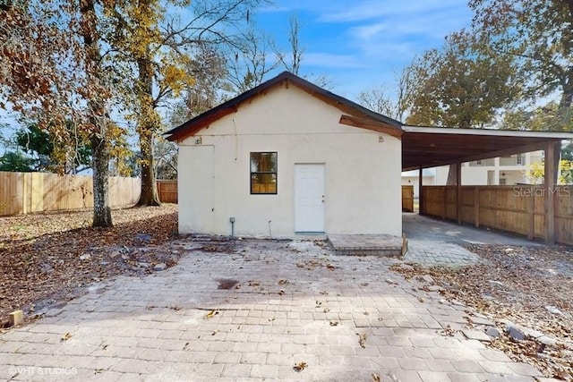 back of property featuring a carport