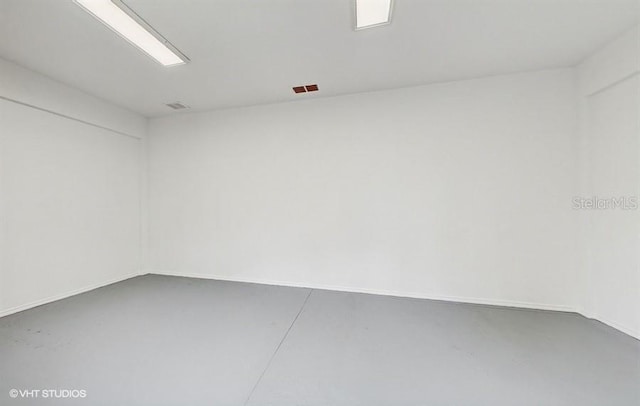 empty room with concrete flooring