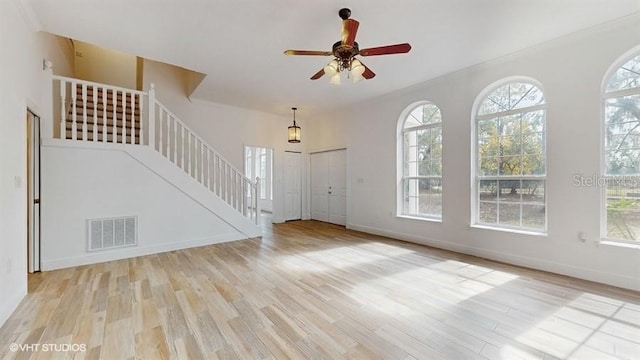 unfurnished living room with ceiling fan and light wood-type flooring