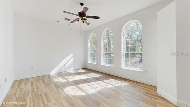 empty room with light hardwood / wood-style flooring and ceiling fan