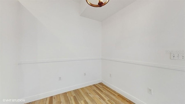 unfurnished room with hardwood / wood-style flooring