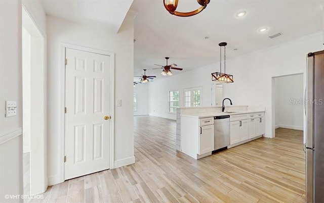 kitchen with decorative light fixtures, white cabinetry, ceiling fan, light hardwood / wood-style floors, and stainless steel appliances