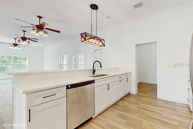 kitchen with sink, dishwasher, pendant lighting, light hardwood / wood-style floors, and white cabinets