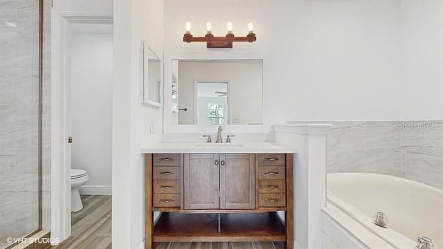 full bathroom with wood-type flooring, toilet, vanity, and plus walk in shower