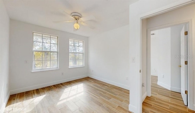 empty room featuring ceiling fan and light wood-type flooring