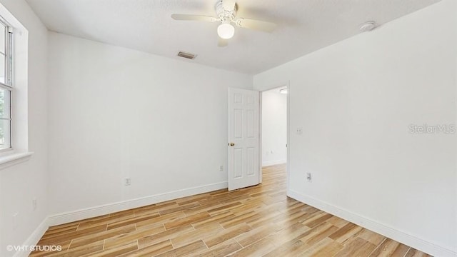 unfurnished room with ceiling fan and light wood-type flooring