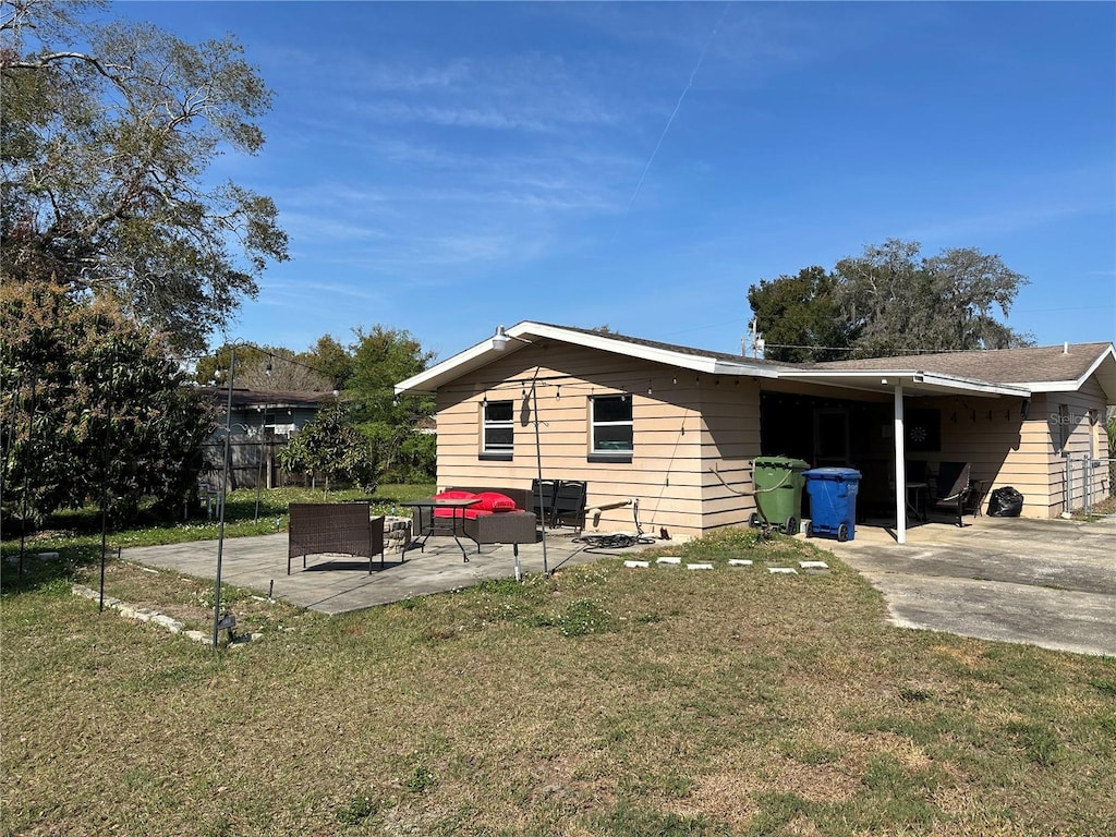 view of side of home featuring a yard, outdoor lounge area, and a patio area