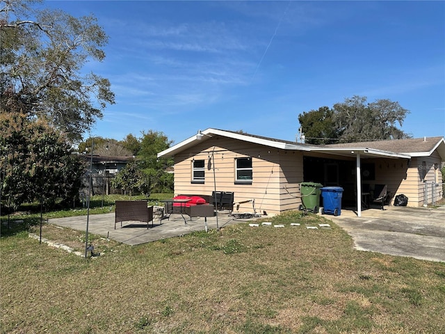 view of side of home featuring a yard, outdoor lounge area, and a patio area