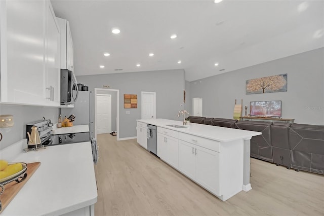 kitchen featuring lofted ceiling, sink, a kitchen island with sink, white cabinetry, and stainless steel appliances