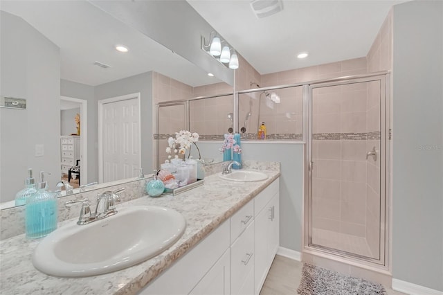 bathroom featuring walk in shower and vanity