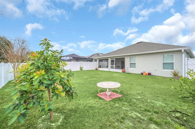 back of property featuring a yard and a sunroom