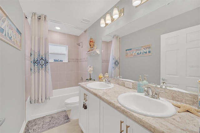 full bathroom featuring tile patterned flooring, vanity, shower / tub combo with curtain, and toilet