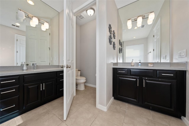 bathroom featuring vanity, tile patterned flooring, and toilet