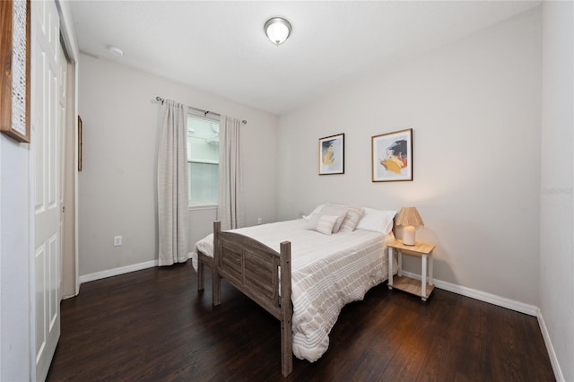 bedroom with dark hardwood / wood-style floors