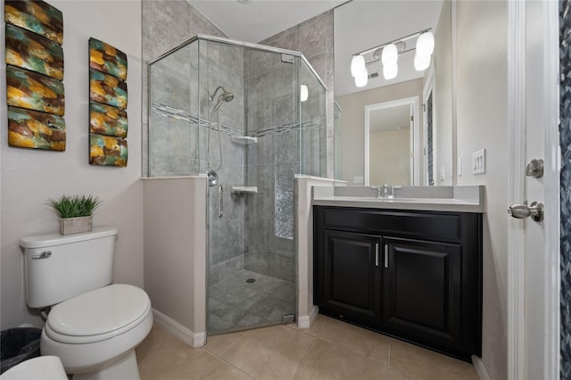 bathroom with vanity, tile patterned flooring, a shower with door, and toilet