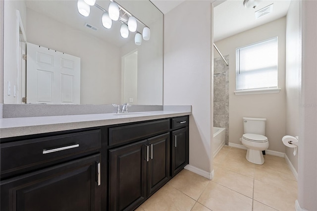 full bathroom with vanity, tiled shower / bath, tile patterned floors, and toilet