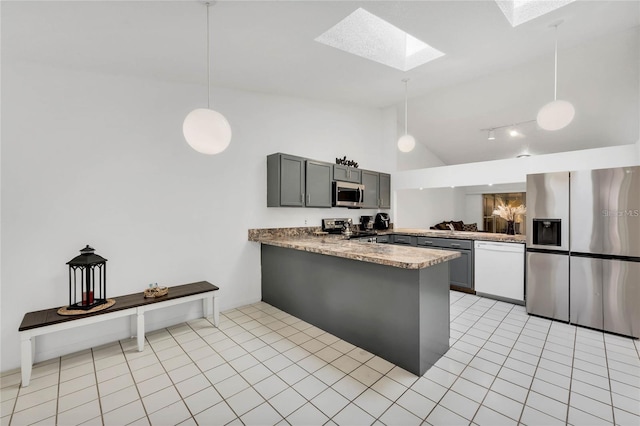 kitchen with light tile patterned floors, gray cabinets, hanging light fixtures, stainless steel appliances, and kitchen peninsula