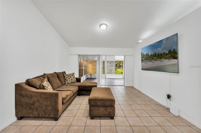 living room with light tile patterned flooring and a textured ceiling