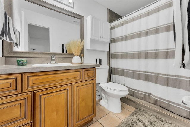 bathroom featuring vanity, toilet, and tile patterned flooring