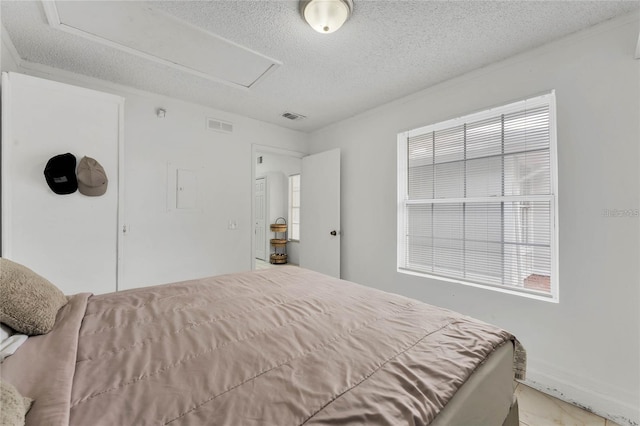 bedroom featuring multiple windows and a textured ceiling